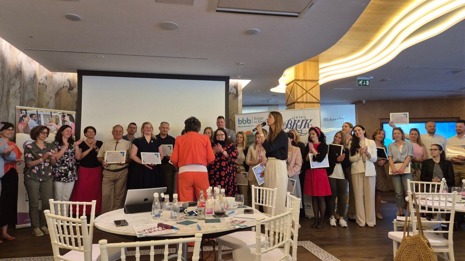 Participants with their certificates at the Bridge to Benefits final pitch event in Budapest
