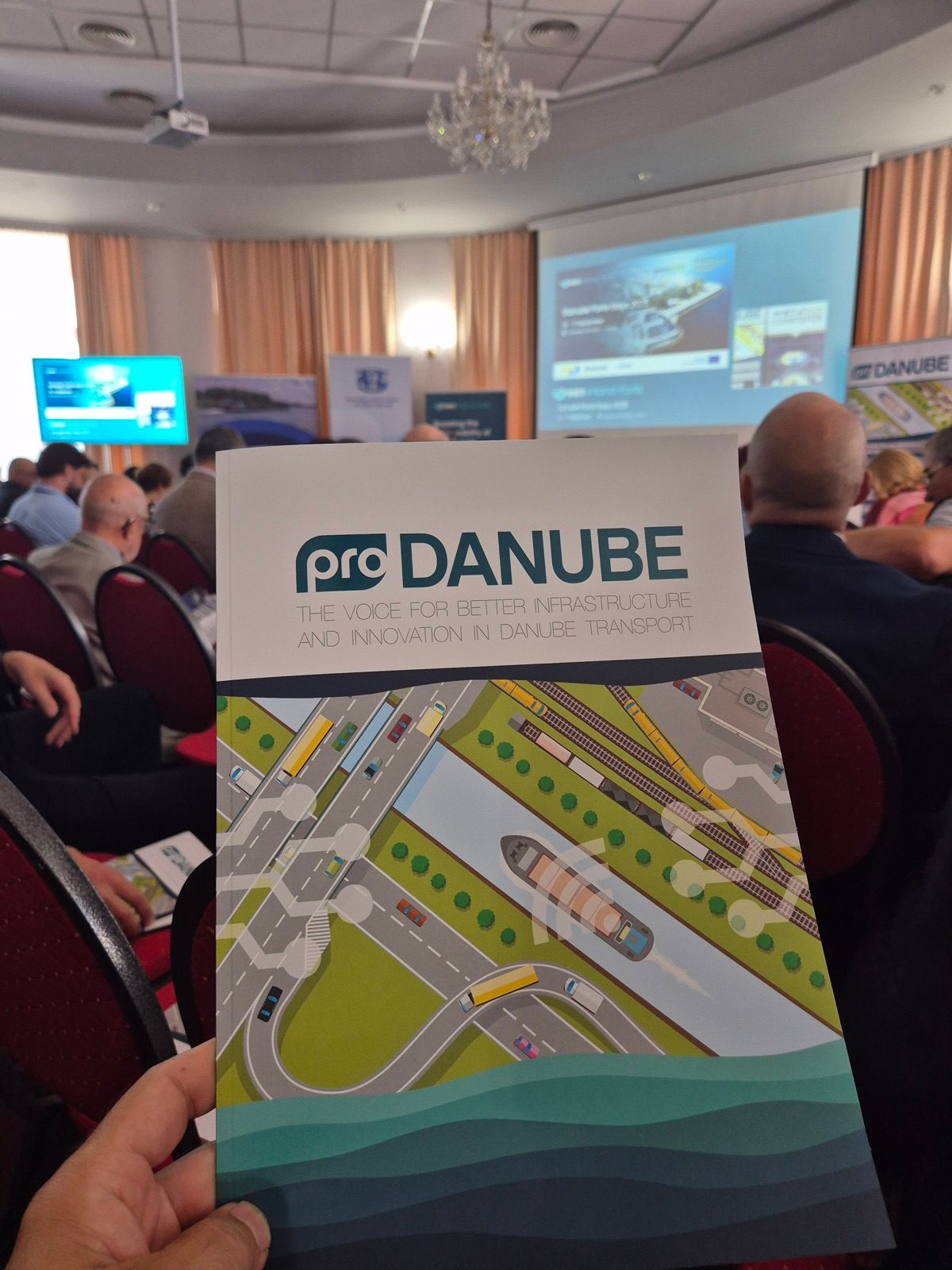 A Pro Danube brochure held up in the conference hall at the Danube Ports Days in Constanta